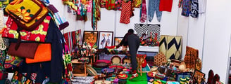 uthentic African products including vibrant clothes, traditional heritage items, handcrafted jewelry, aromatic food spices, a