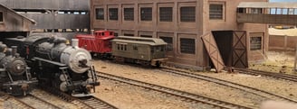Steam train, Caboose with surronding buildings.