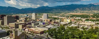 A Colorado Springs skyline view with the Rocky Mountains in the background