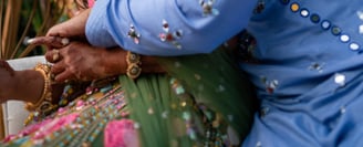 a man and woman in a colorful dress and a man in a blue suit