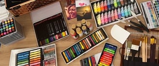 a table with a variety of art supplies and supplies