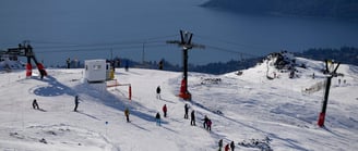 Cerro Catedral Bariloche a ski lift with people skiing down a mountain
