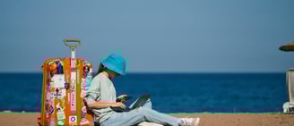 a digital nomad working from a beach