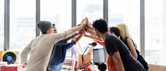 a group of co-workers high fiving