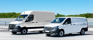 two vans parked in a parking lot