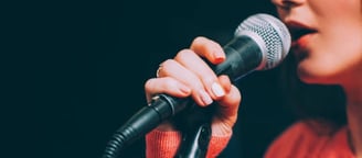 a woman in a red sweater and a microphone