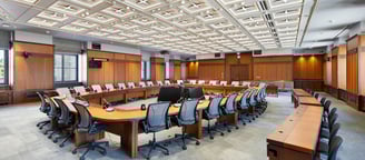 a conference room with a large wooden table and chairs