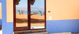 Studio with large door with a view of a beach