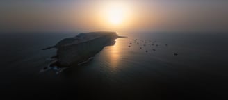 a large body of water with a boat in the water. arbab naimat kasi balochistan Astola