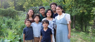 The Schauder Family in front of their garden. 
