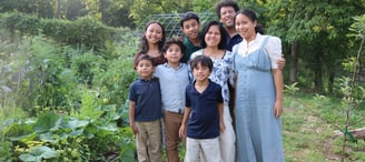 The Schauder Family in front of their garden. 