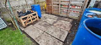 a wooden pallet with a crate of wood and paved area