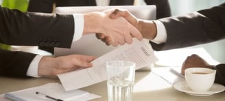 a business meeting with a handshake of two people