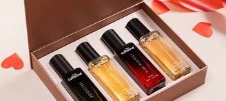a box of perfumes with a red ribbon
