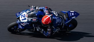 a person riding a motorcycle on a track