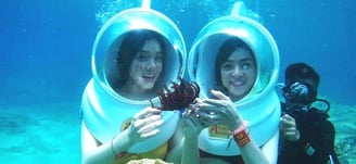 two people in scuba suits are posing for a picture