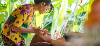 a woman getting a facial massage at a spa