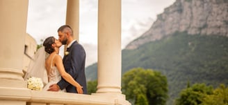 a bride and groom standing on a balcony