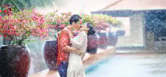 Young couple in love, guy and girl, Europeans, kiss in the rain on Koh Samui, Thailand
