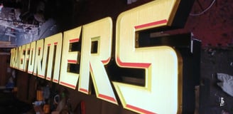 a large iluminated sign of transformers
