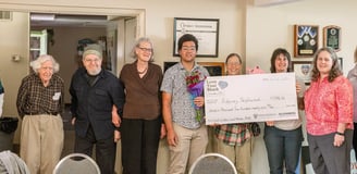 Everyone who was awarded a grant posing for a photo with a large check