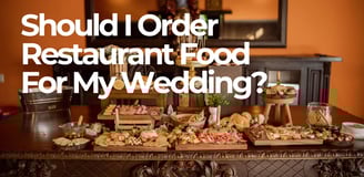 a table with food and drinks on it with the words should i order restaurant food for my wedding