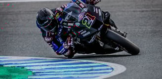a person riding a motorcycle on a track