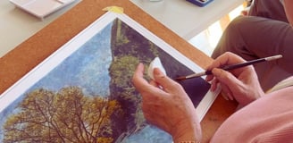Woman creating a fine art photograph using a paint brush