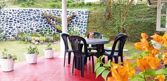 Outdoor dining area at Nobel Bungalow Nuwara Eliya with flowers and garden view
