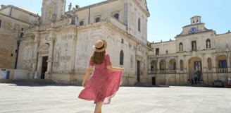 A girl dressed in pink walking in Lecce city center