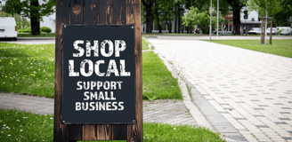a sign board with a sign saying shop local