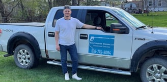 Boss Pressure Washing LLC owner Torsten Boss standing next to branded service truck.