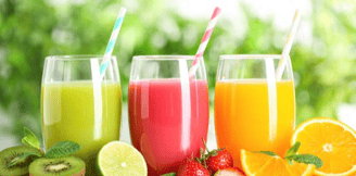 a variety of fruits and vegetables in a row of glasses