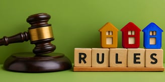 blocks spelling "rules", judge's gavel and miniature houses