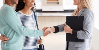 Professional organizer greeting happy clients during a home consultation in Miami.
