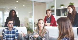 a group of people sitting around a couch