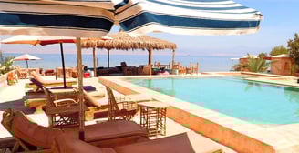 Bedouin star ras shitan lounging under the umbrella