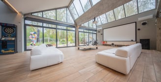 a living room with a large screen tv and a large screen tv