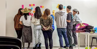 a group of people working together in a behaviour change sprint