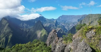 a person on a mountain top with a view of mountains