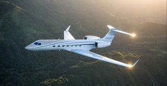 Gulfstream 550 aircraft picture flying over mountains.