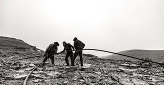 a group of men working on a rocky mountain