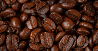 a close up of a pile of dark roast coffee beans