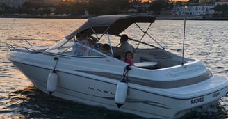 Family enjoying private boat tour at sunset on the Douro River in Porto, Portugal