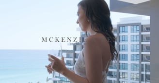 Image of a woman in a luxurious hotel in Los Cabos holding a champagne glass with the sea in the background. Example of our c