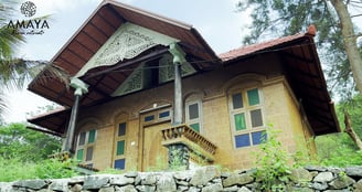 a house with a stone wall and a stone wall