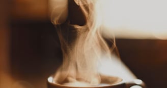 A steaming cup of coffee on a cozy table – symbolizing the start of a focused, energized morning.