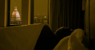 A person sleeping peacefully in cozy bedroom night sky– deep sleep self-care and wellness healing.