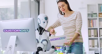 a woman in a striped shirt showing a robot what to do on the computer