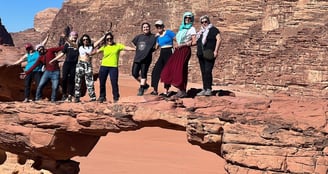 a group of people standing on a rock formation